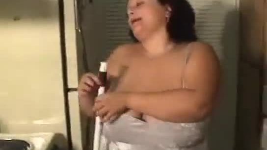 Busty fat woman cleans the house